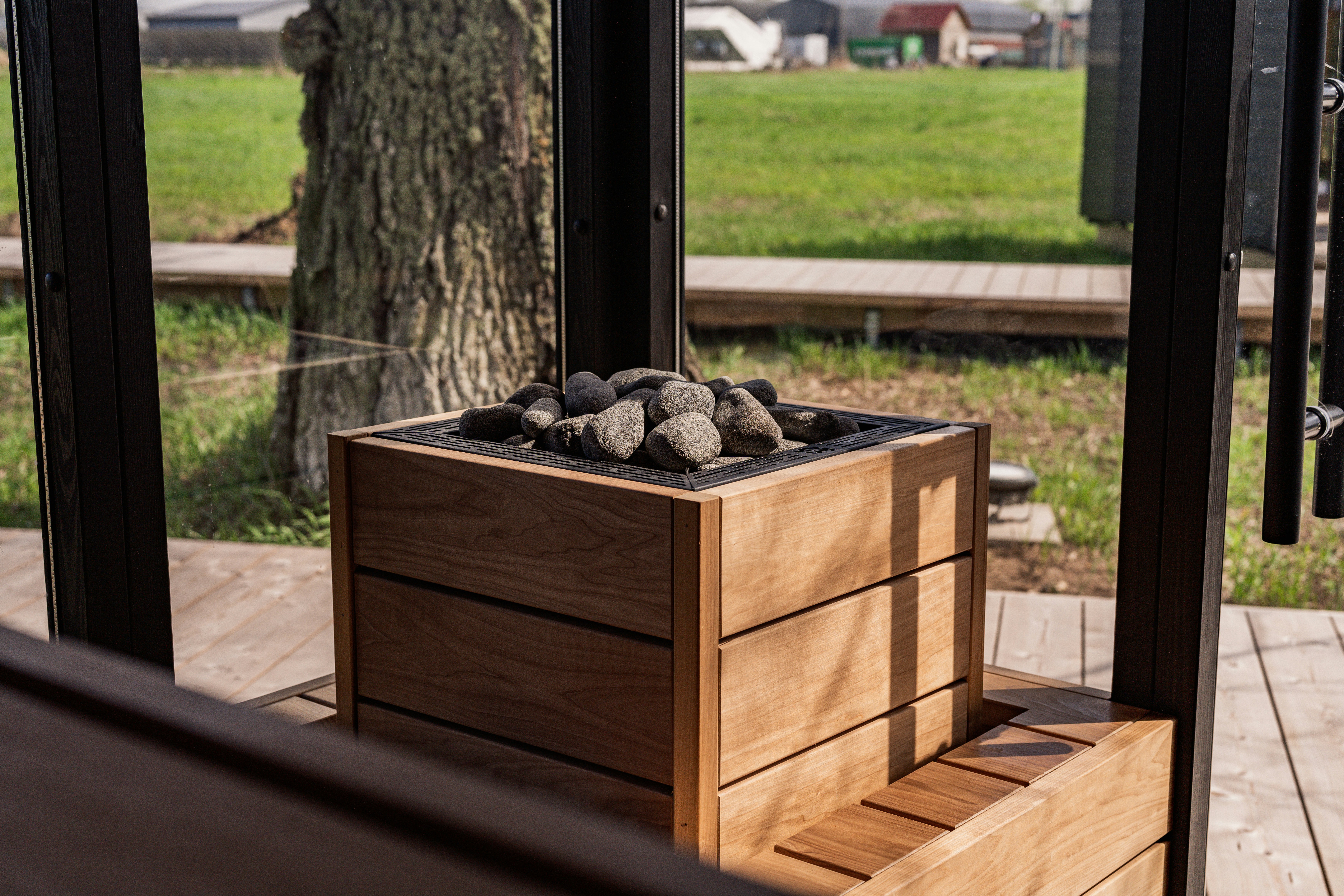 a wooden box filled with rocks sitting on top of a wooden deck