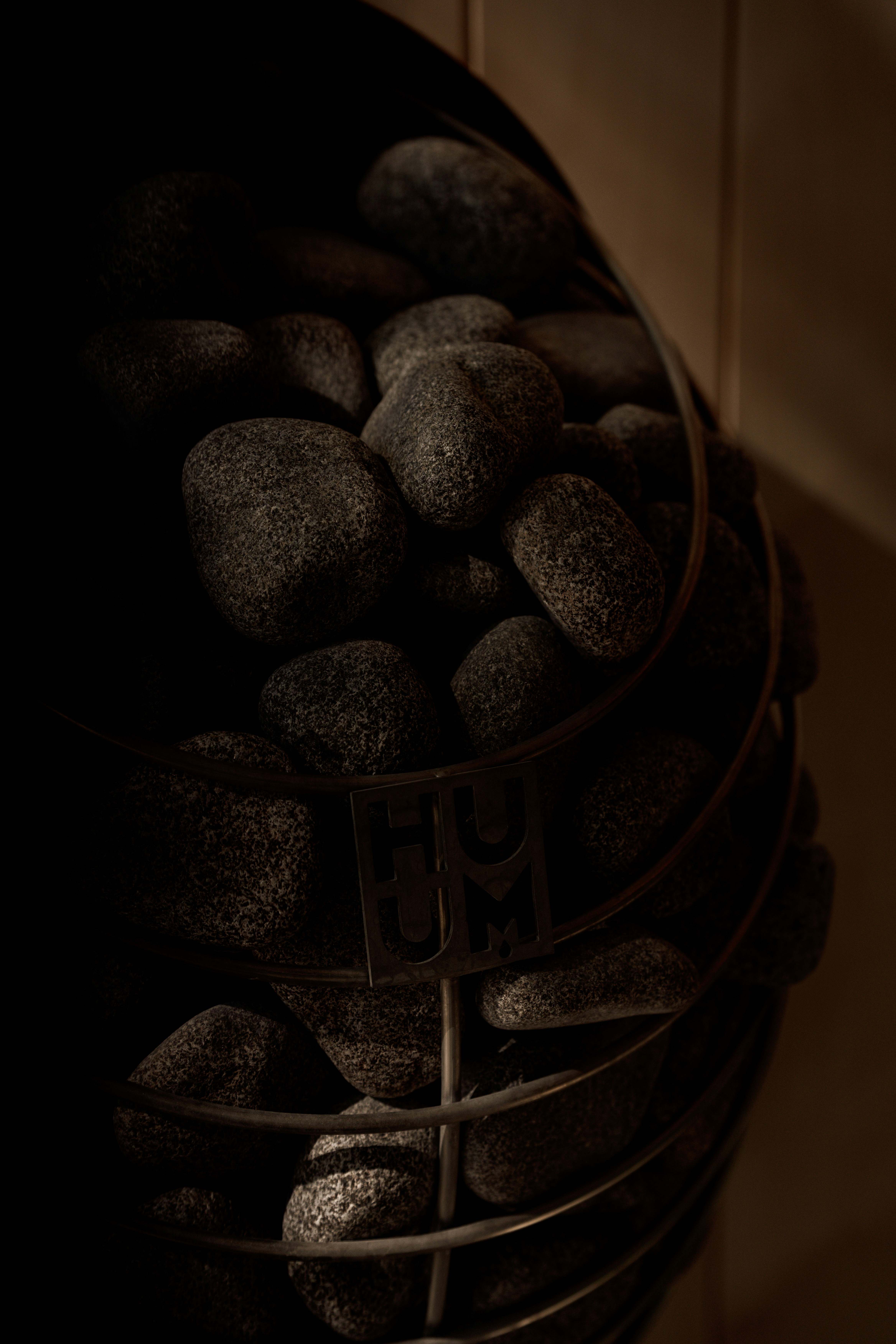 a metal bucket filled with rocks on top of a table