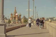 a group of people walking across a bridge
