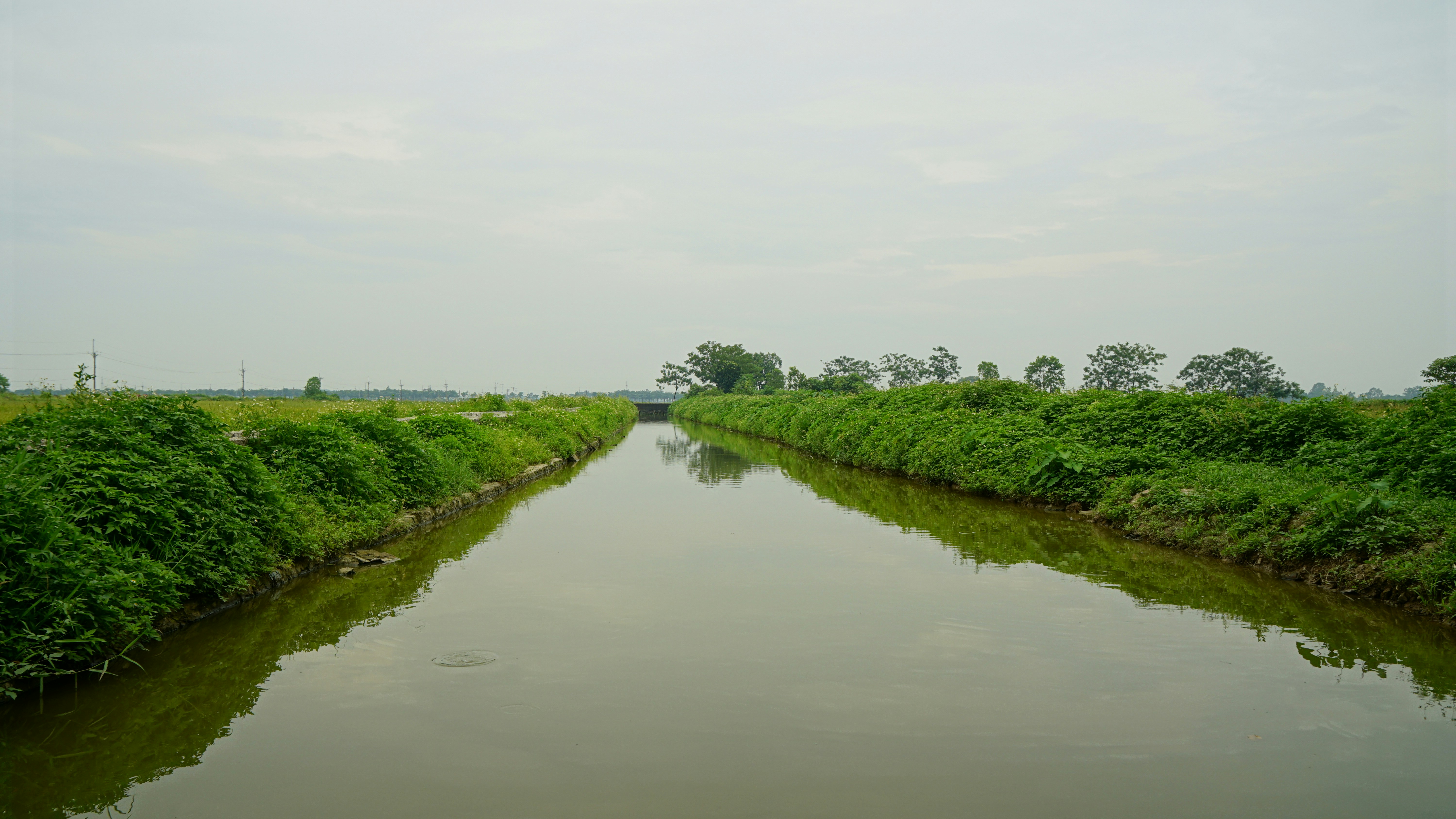A river running through a lush green countryside