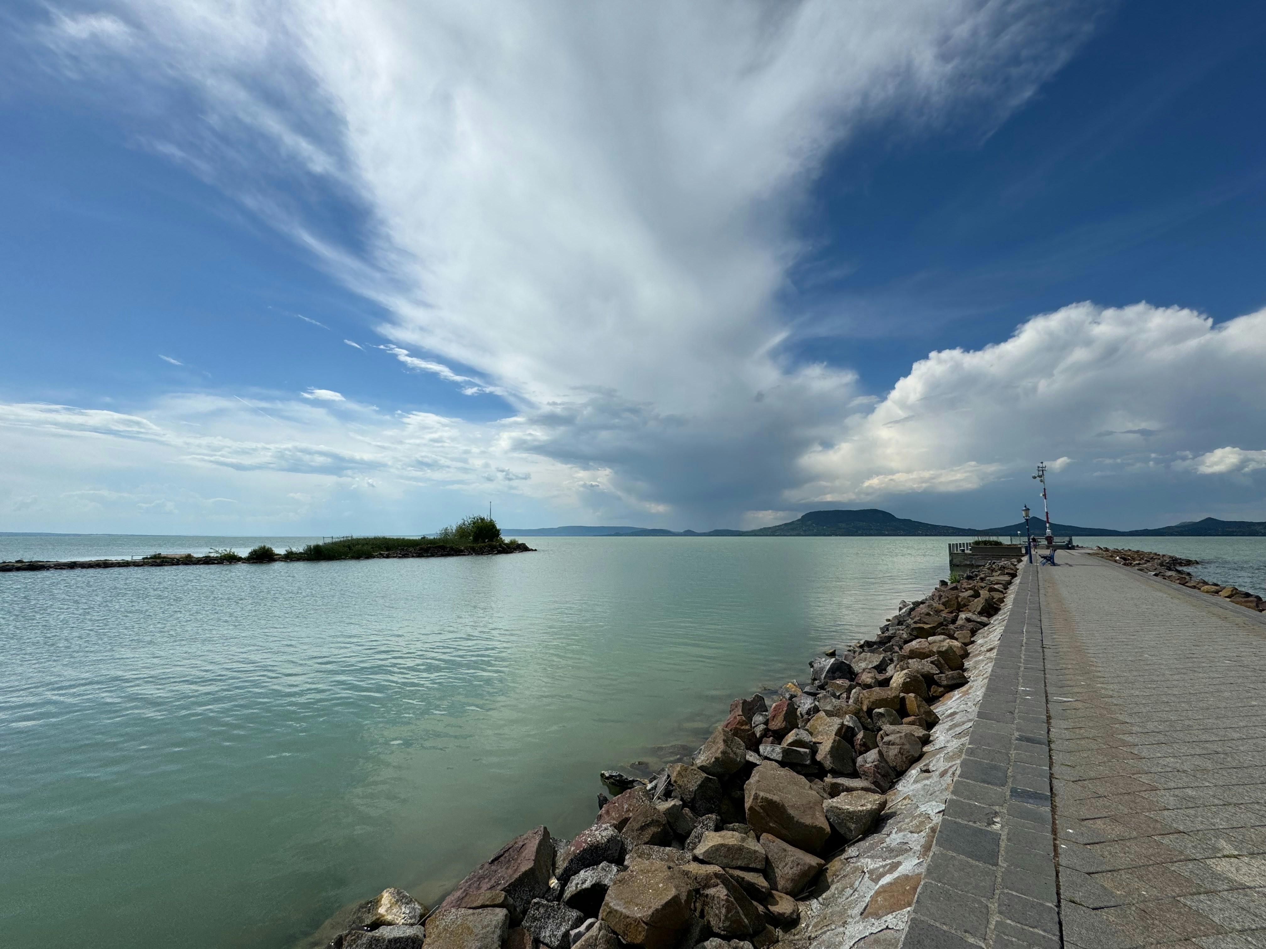 a large body of water sitting next to a stone wall