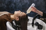a woman getting her hair washed with a hair dryer
