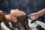 a woman getting her hair washed in a salon