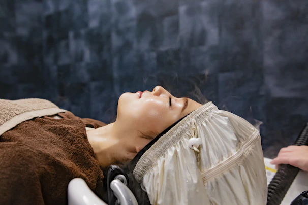 a woman getting her hair brushed by a blow dryer