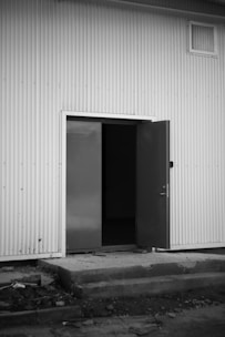 a black and white photo of an open door