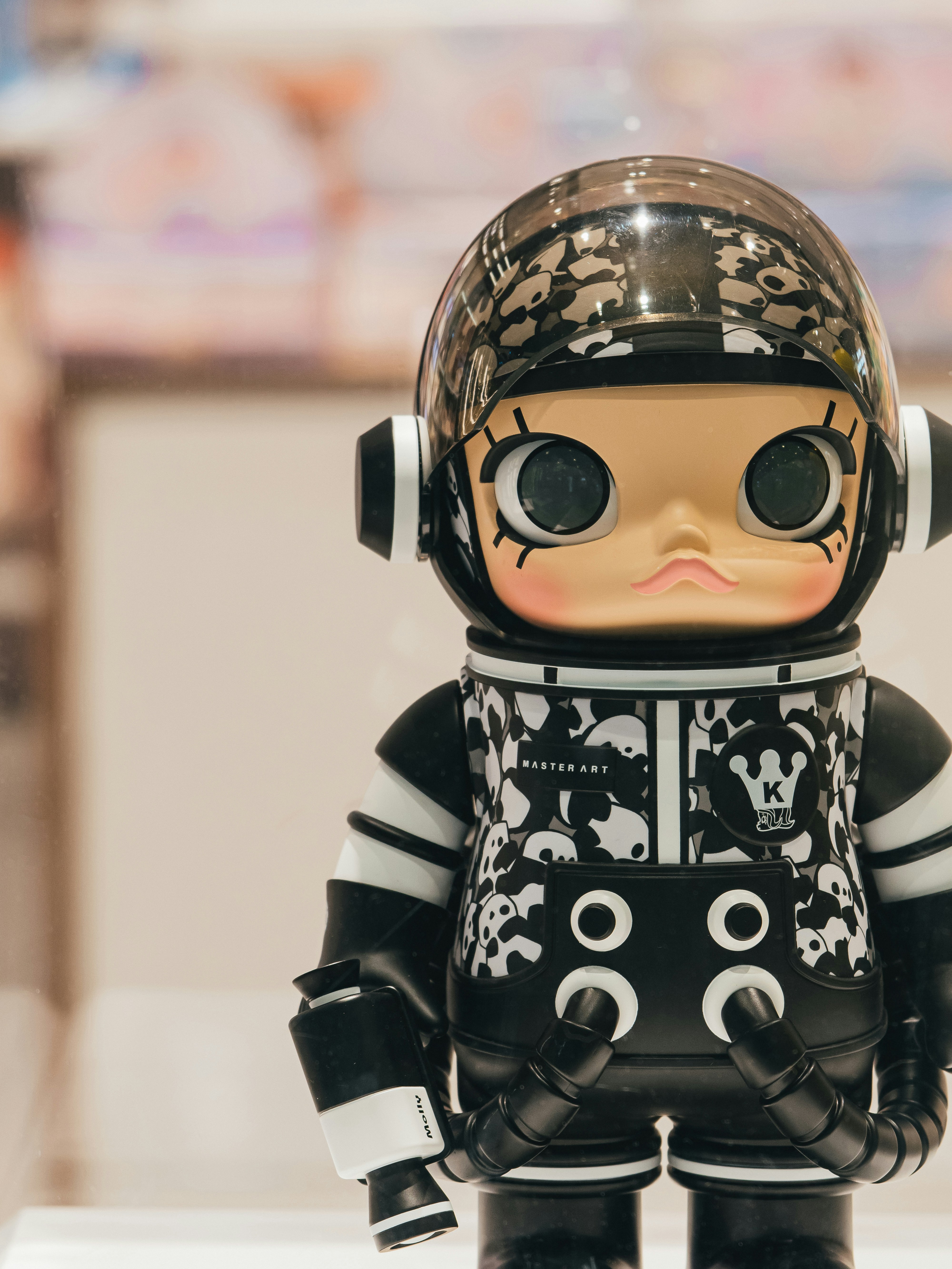 a toy doll wearing a helmet and black and white outfit