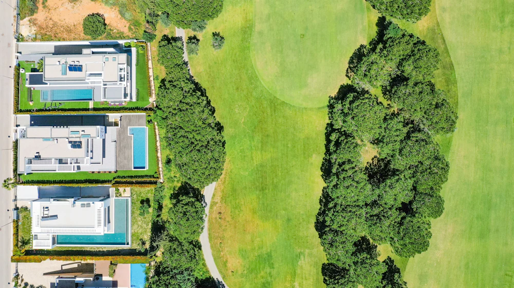 Aerial view of a golf course fairway beside homes