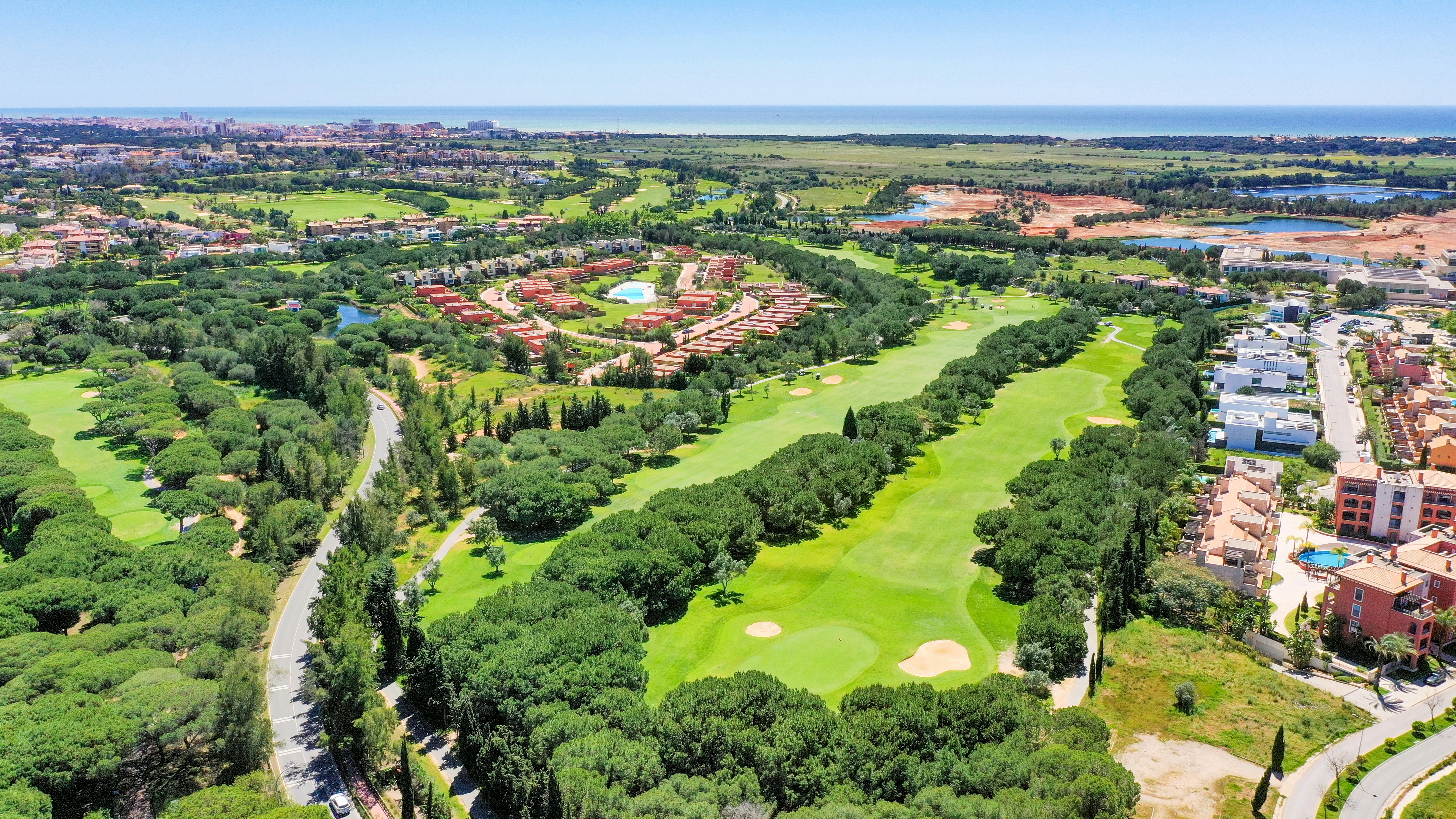 an aerial view of a golf course surrounded by trees, Luxury villa situated in famous golf course in Vilamoura, Algarve, Portugal
