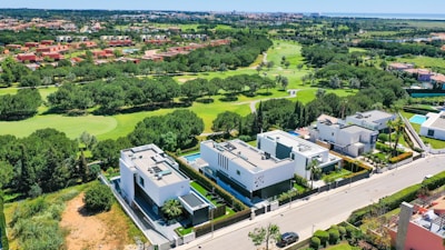 a bird's eye view of a golf course and houses