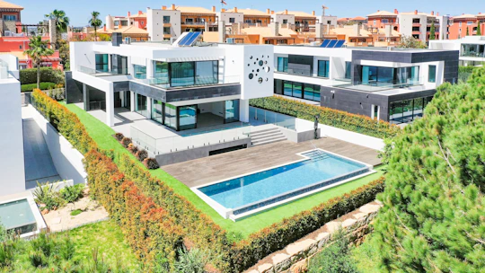 an aerial view of a house with a swimming pool