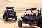 a couple of vehicles that are in the sand