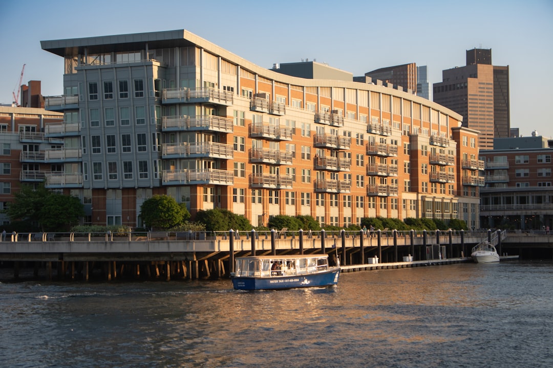 a boat in a body of water near a large building,