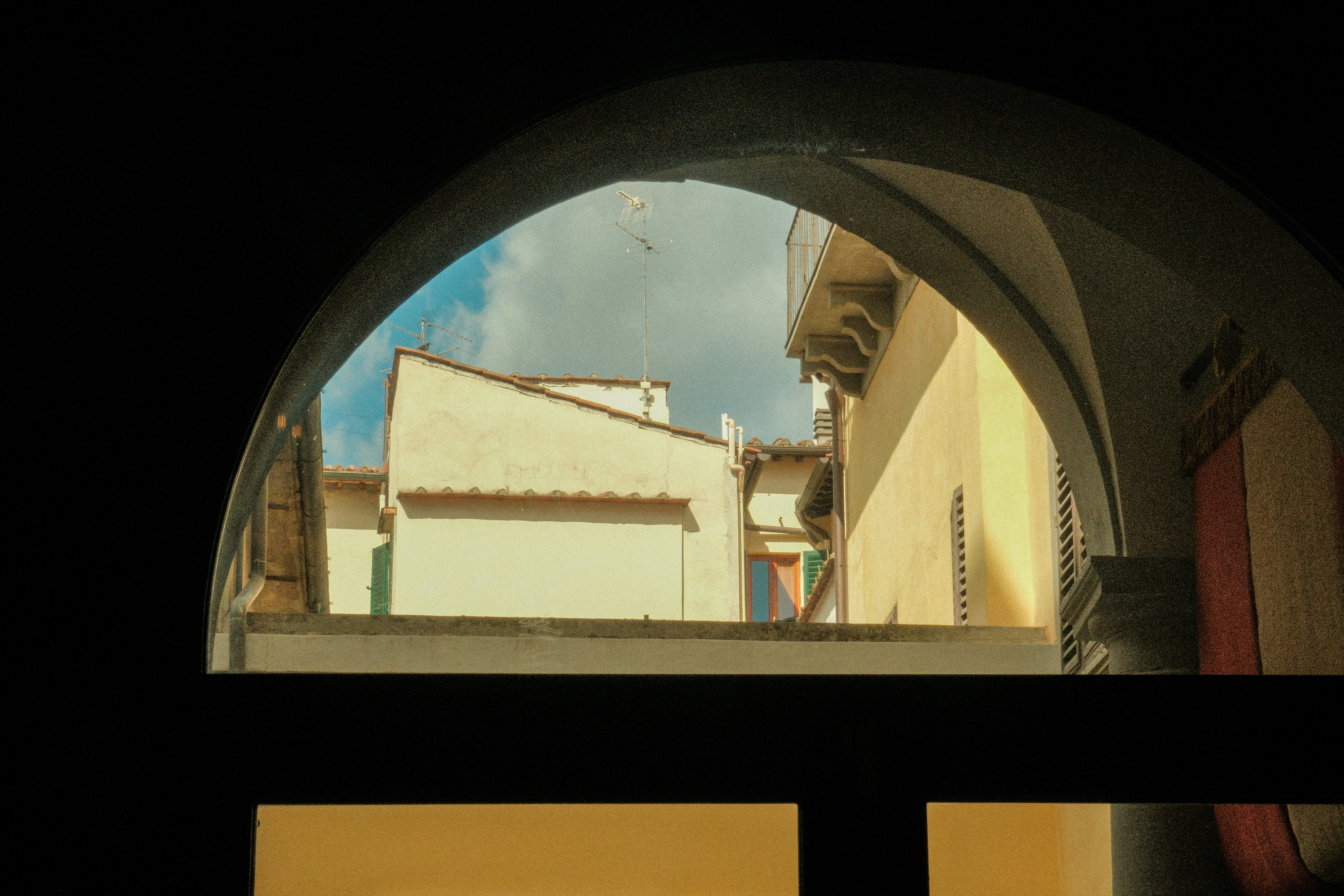 A split image showing an Israeli Iron Dome missile interception on one side and smoke rising from a building on the other.