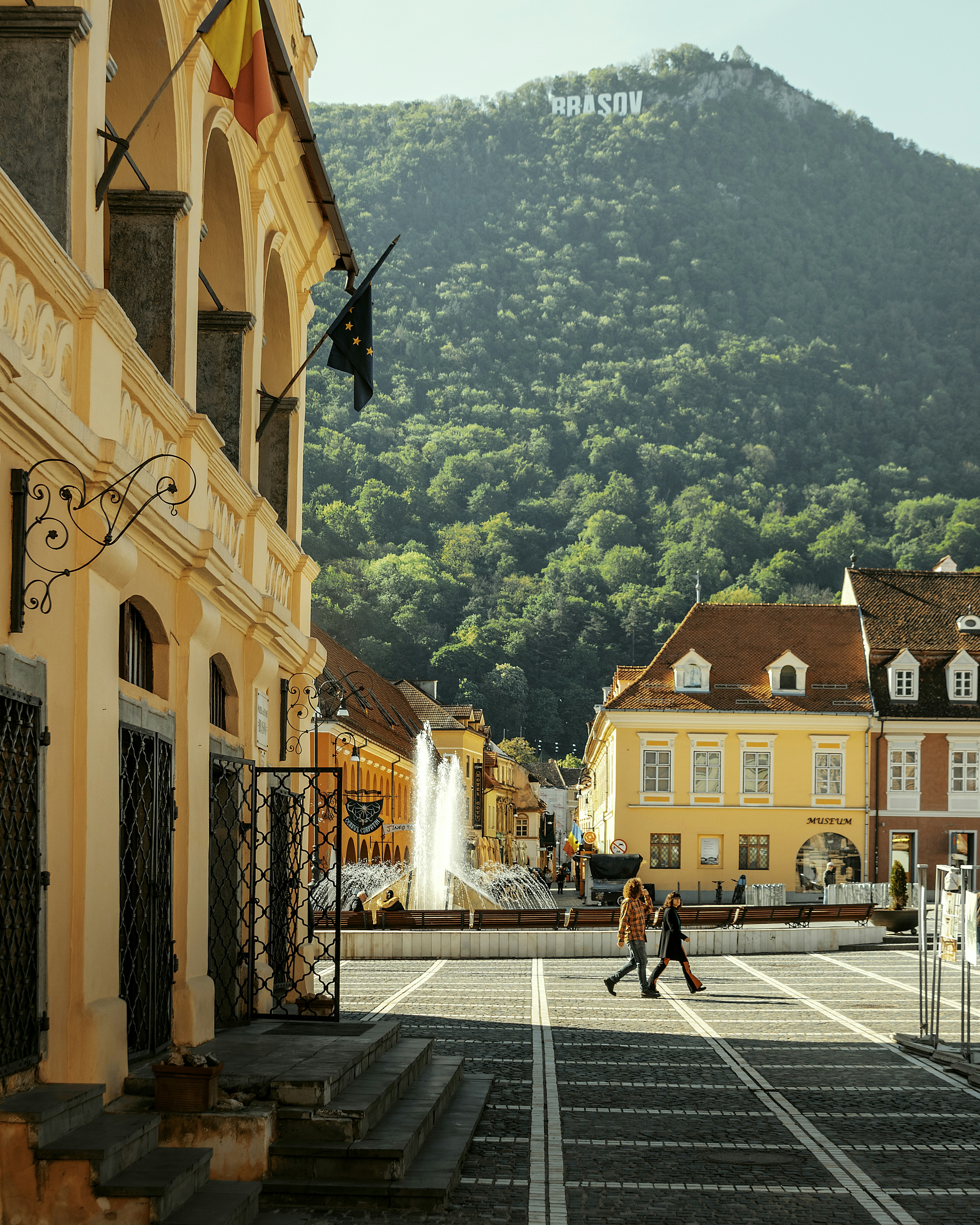 Medieval Brasov city center with colorful buildings and mountain backdrop