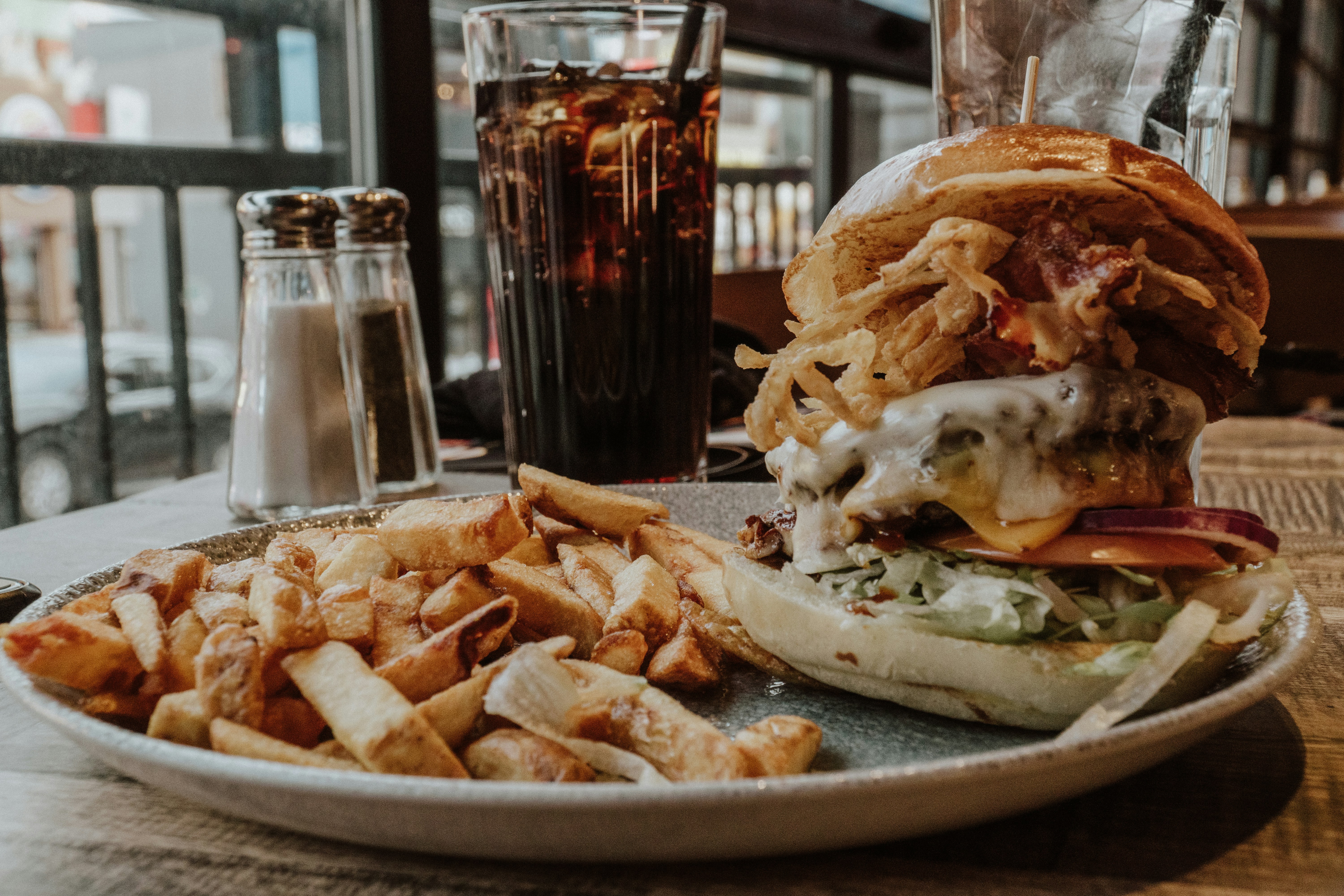 Juicy burger and fries served in a Filipino fast food stall with bright signage