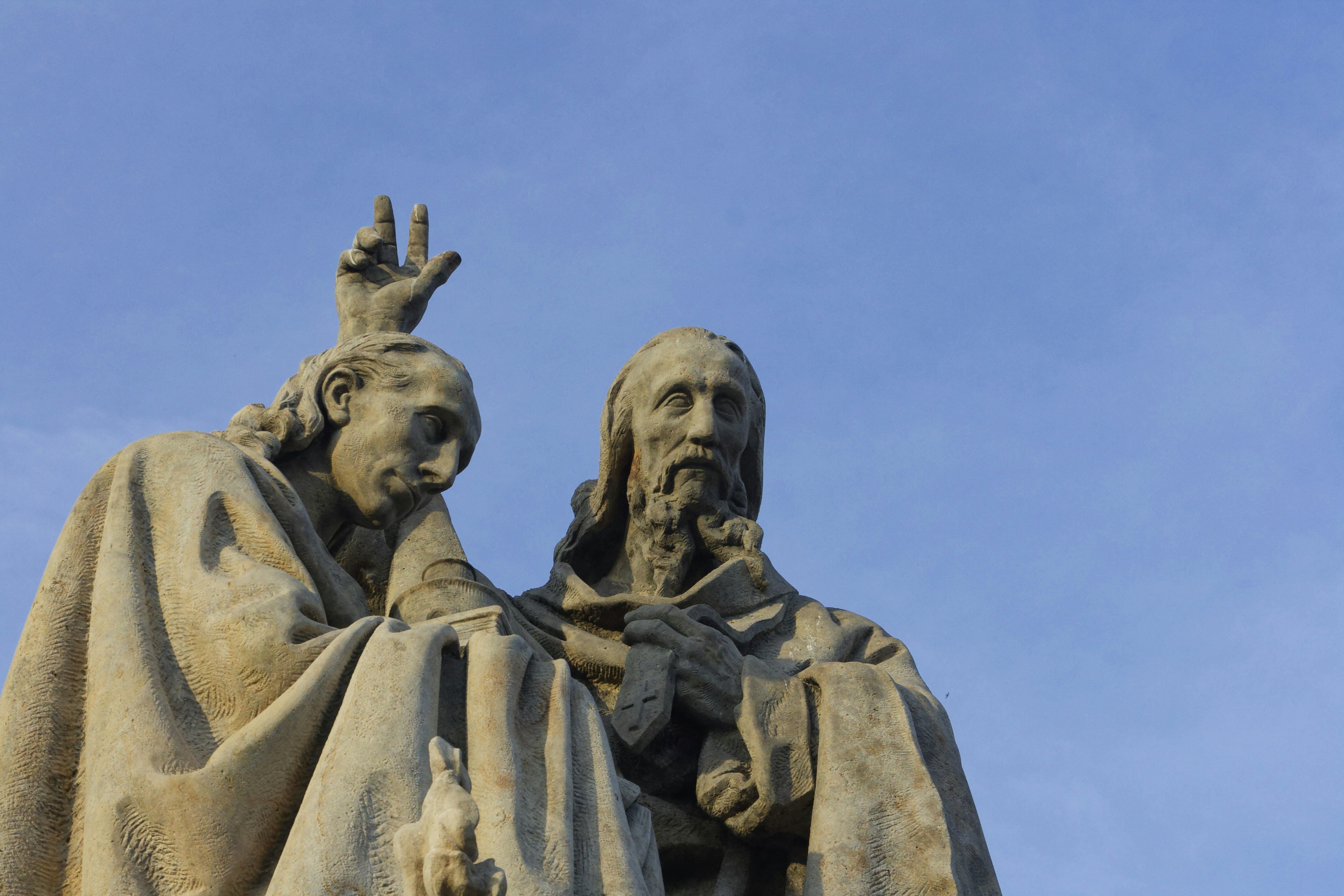 una statua di un uomo e di una donna con le mani in aria