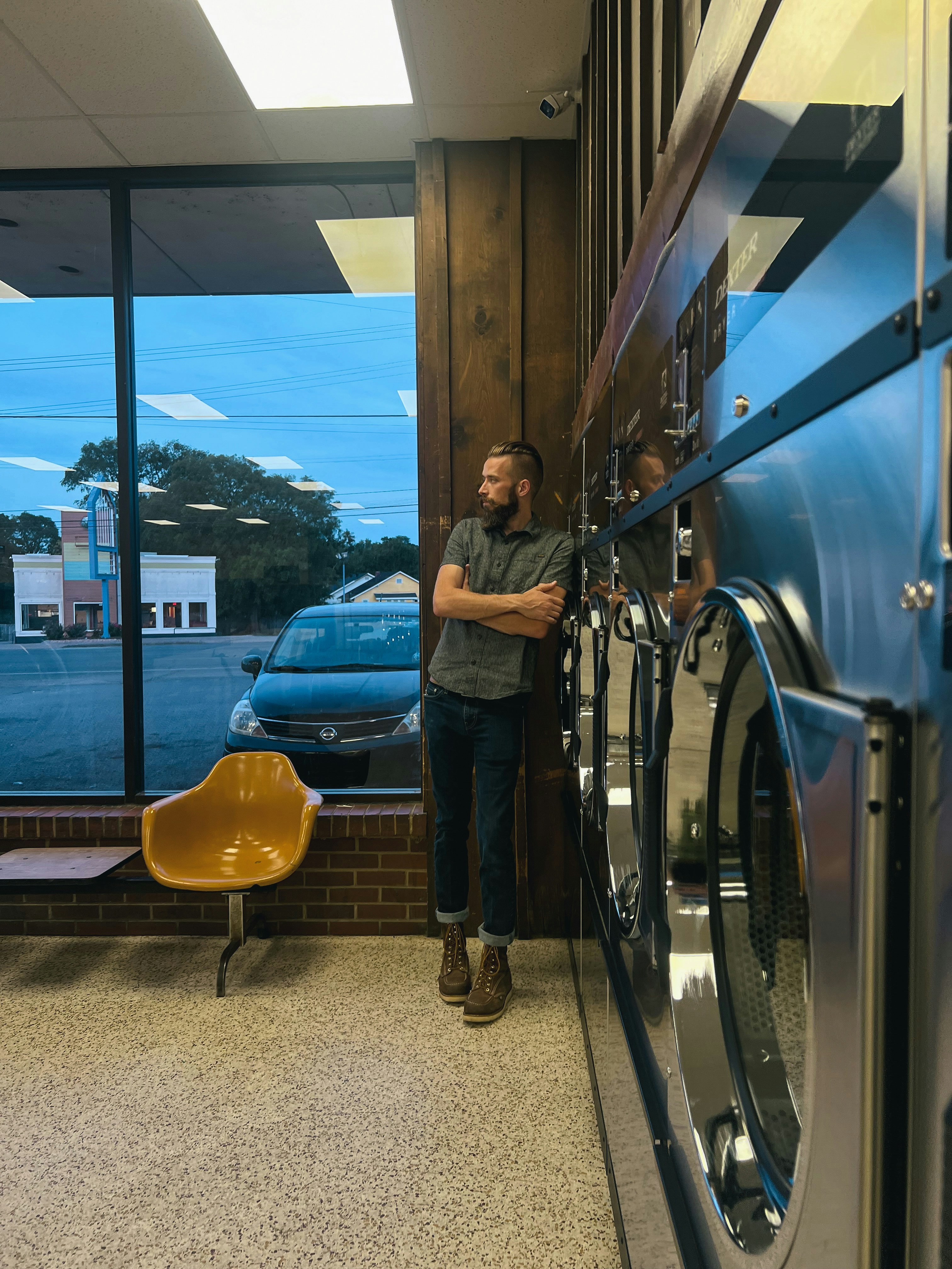 a man standing next to a dryer in a room