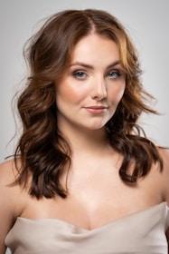 a woman in a strapless dress posing for a picture