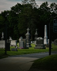 a cemetery with many headstones and crosses