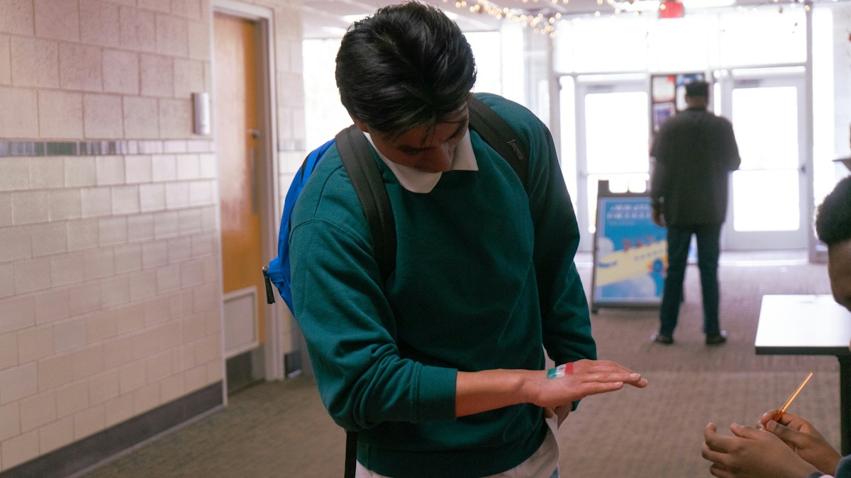 Woman in green sweater holding a stick, illustrating a creative spirit day idea for elementary school activities