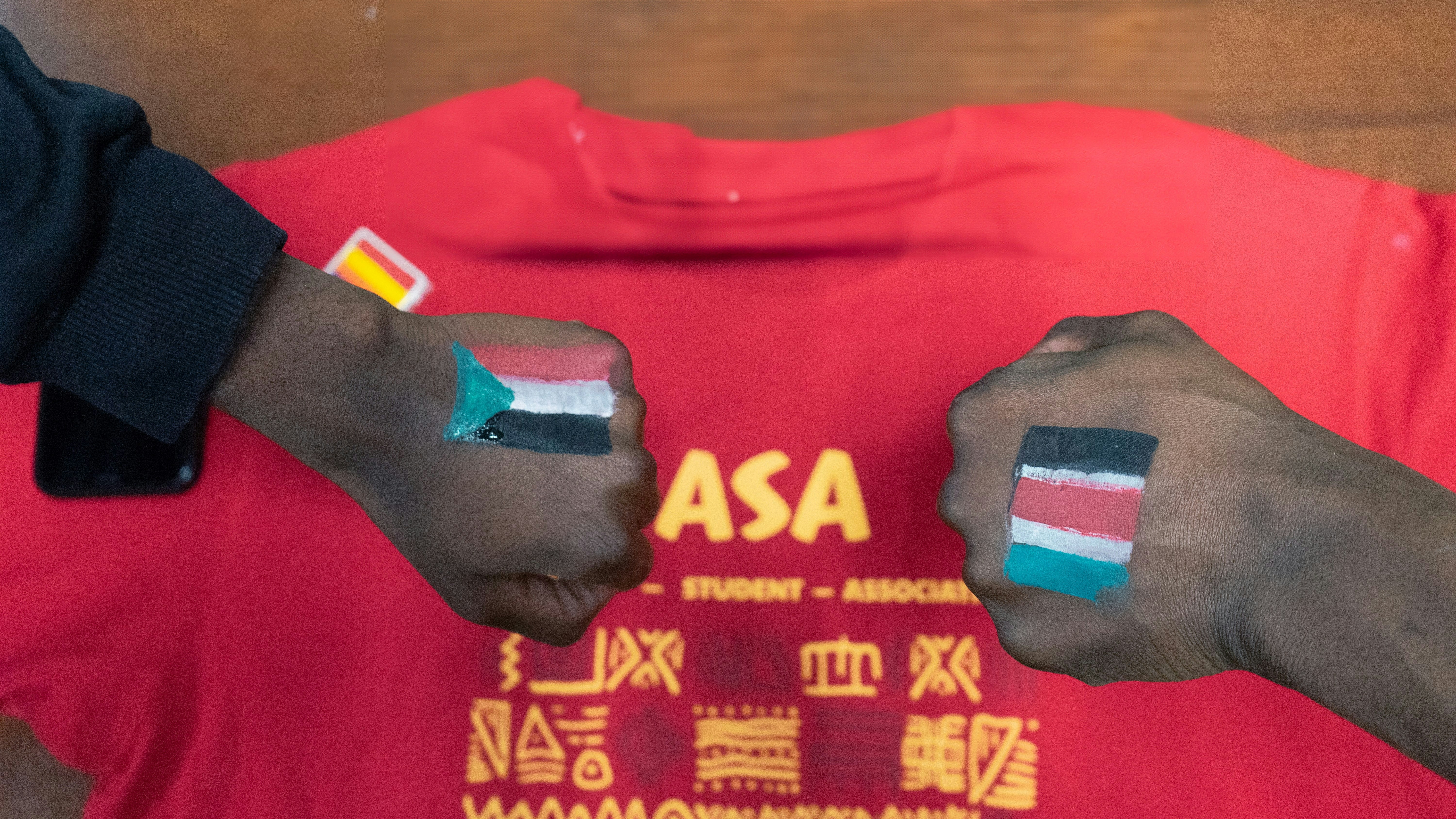 two people with their hands painted with flags