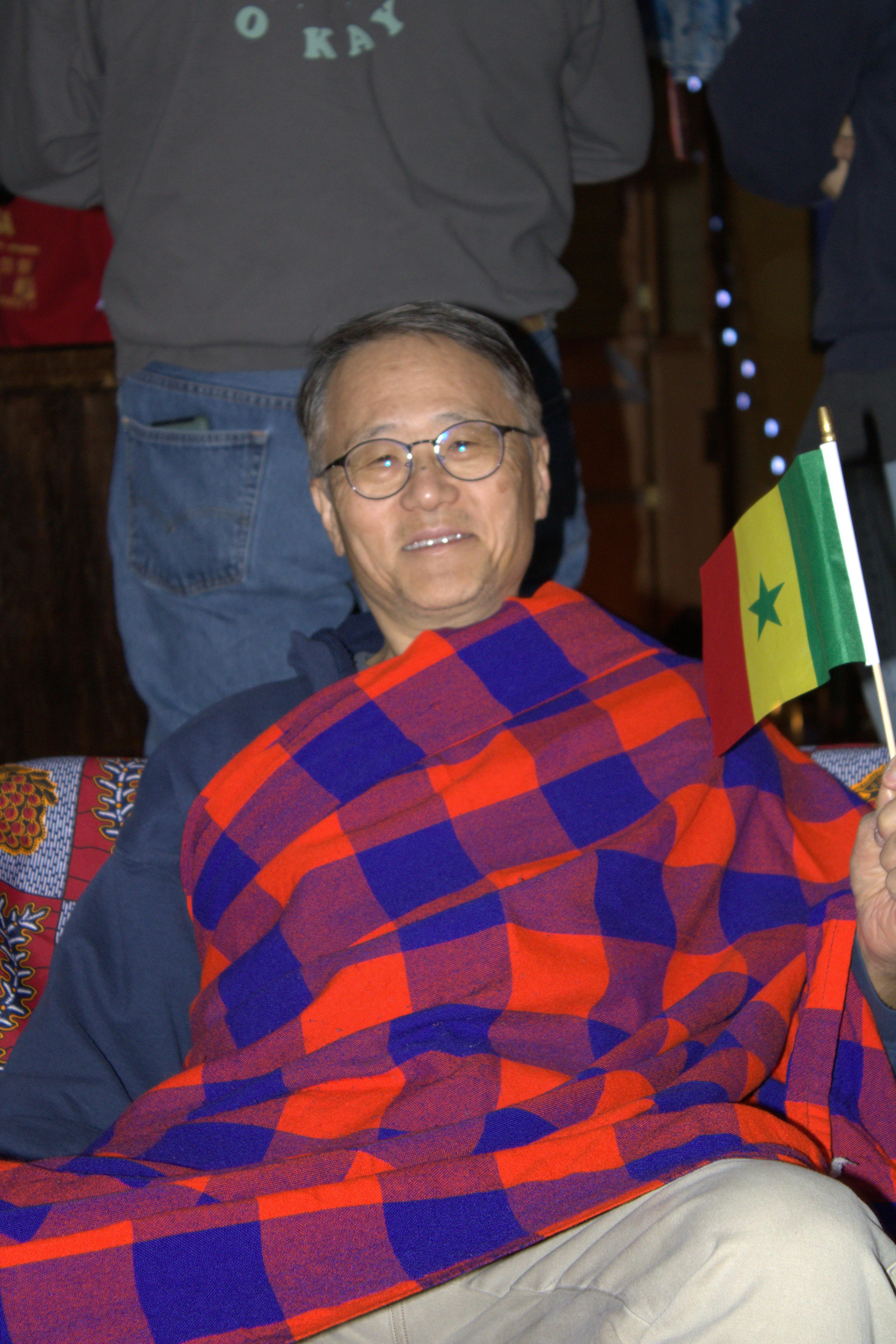 a man sitting on a couch holding a flag