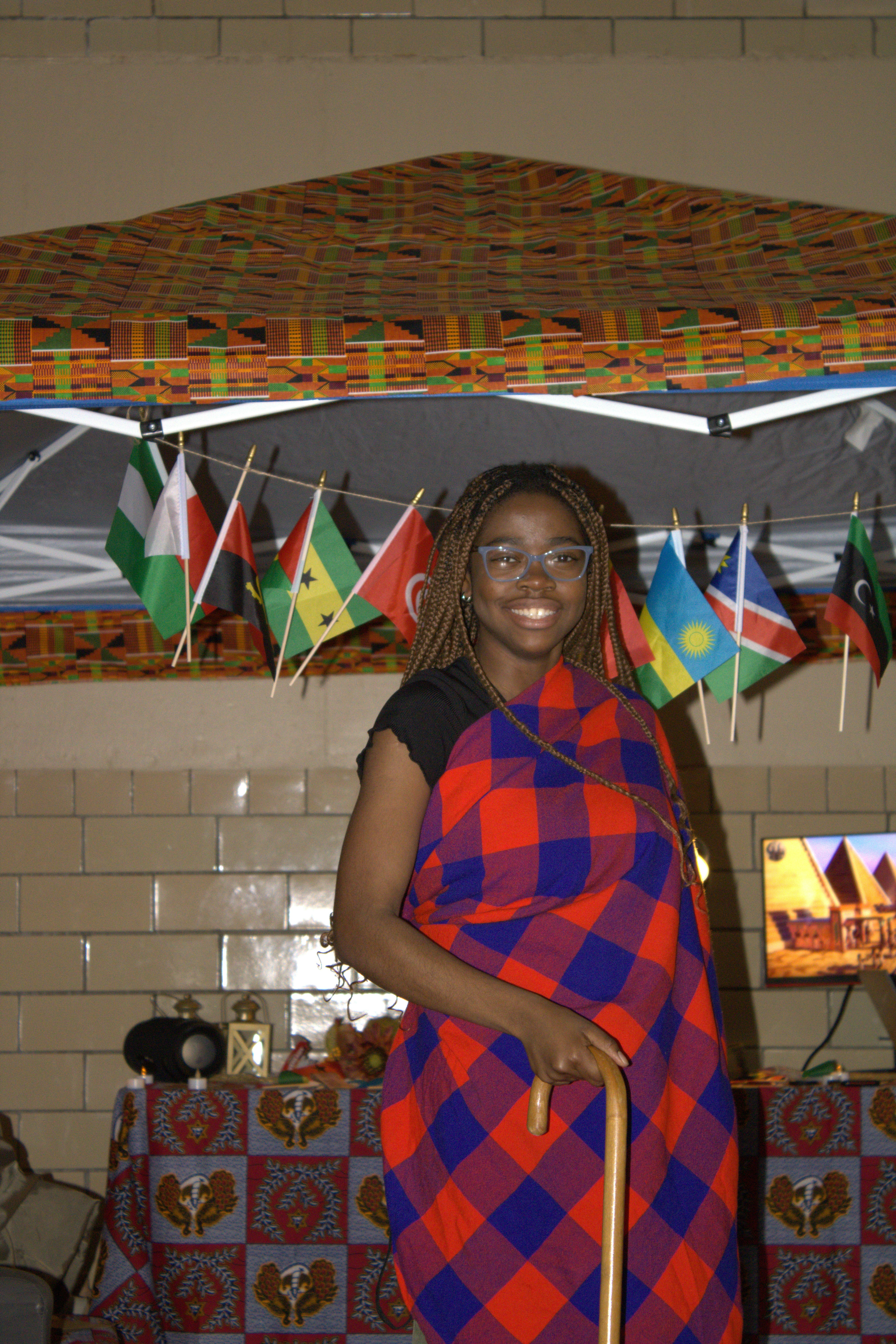 a woman standing under an umbrella in a room