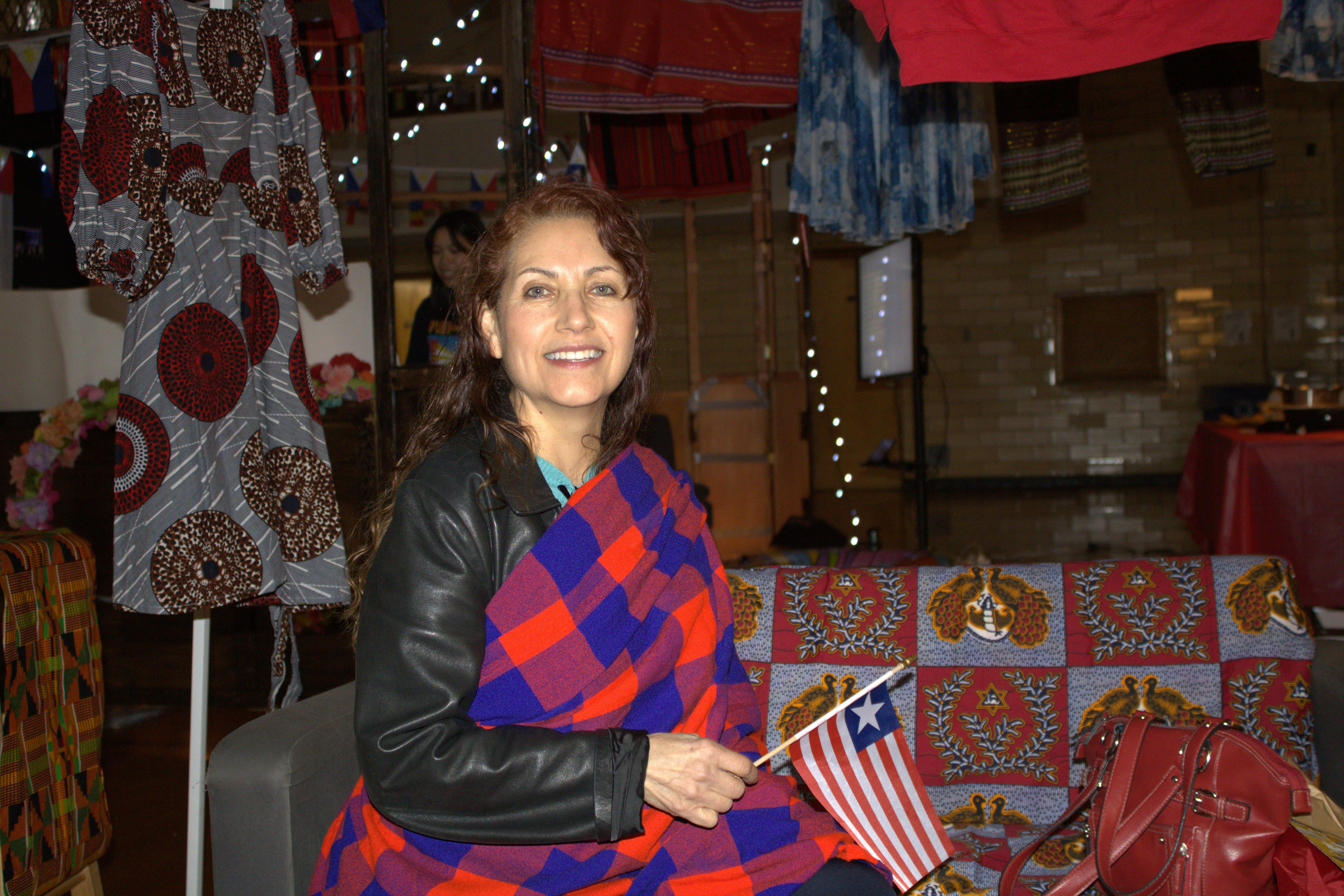 a woman sitting on a chair holding a flag