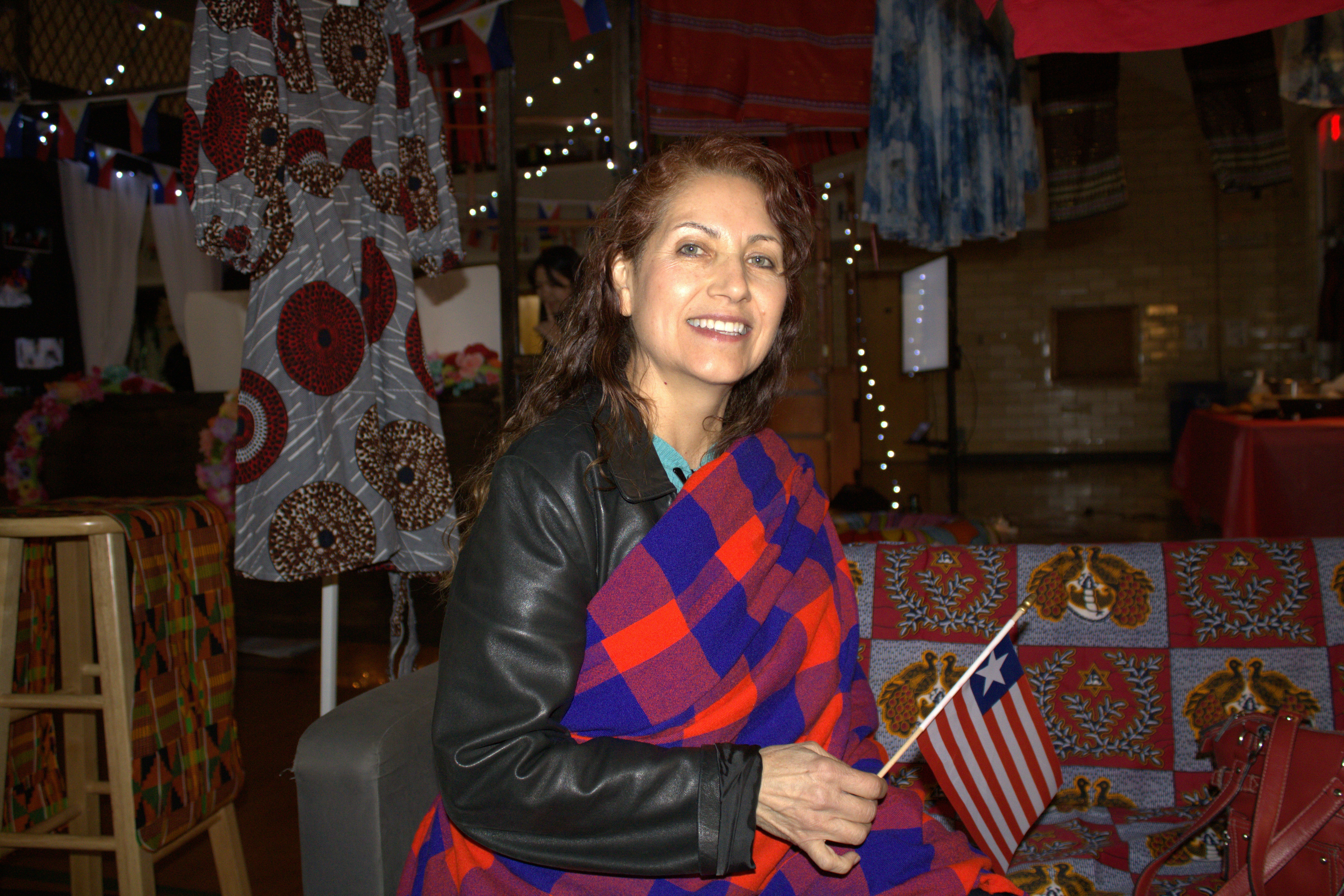 a woman sitting in a chair holding a flag