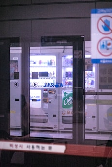 a vending machine is shown through a glass door