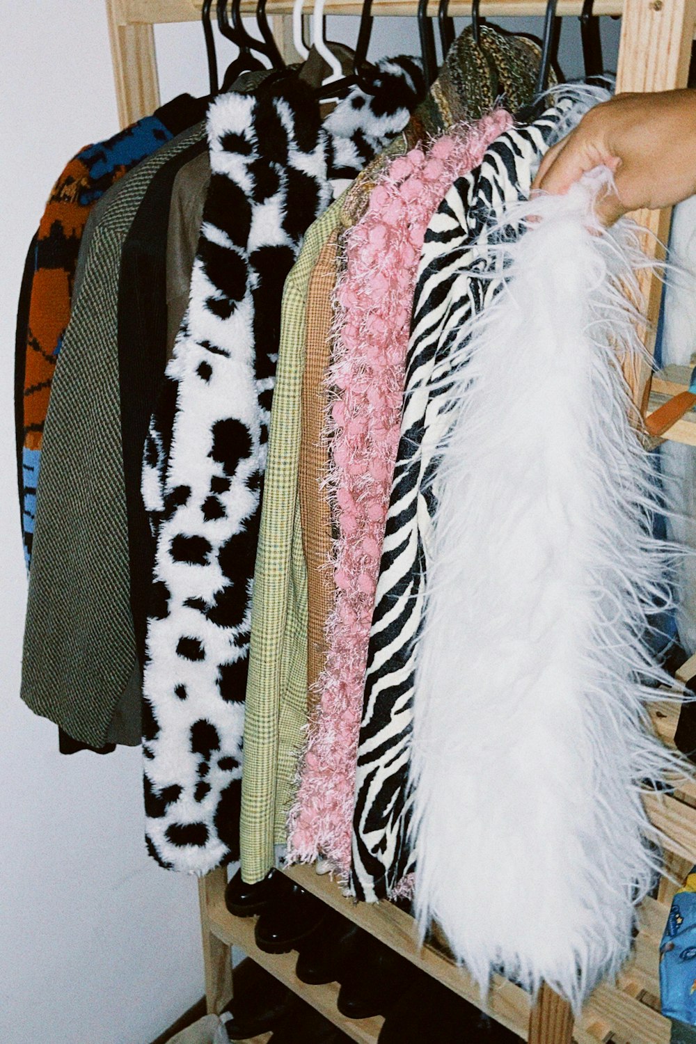 a person is holding a rack of clothes
