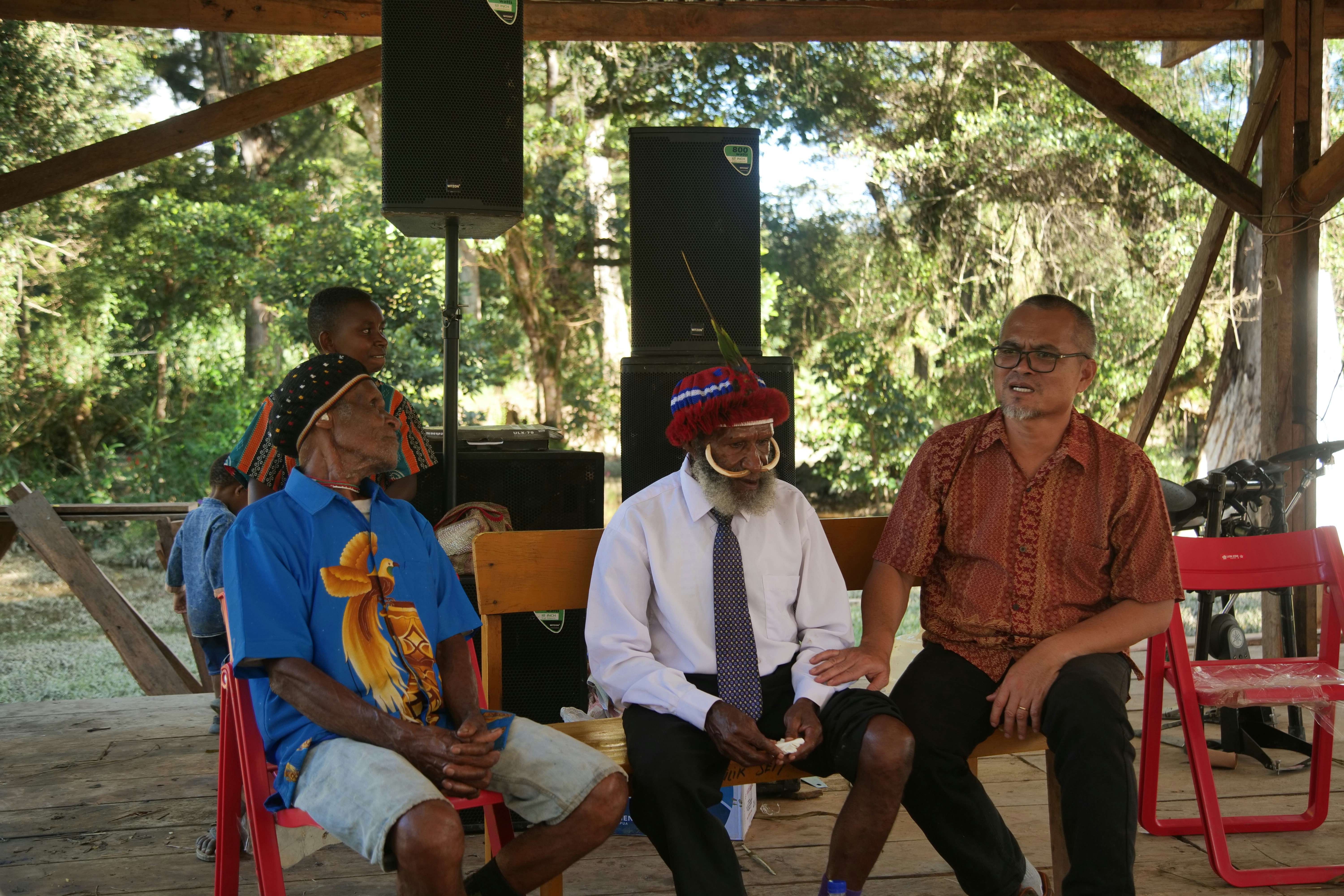 a group of men sitting next to each other