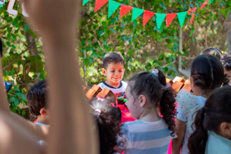 a group of young children standing next to each other