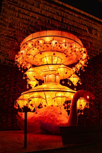 a lit display of lights in front of a building