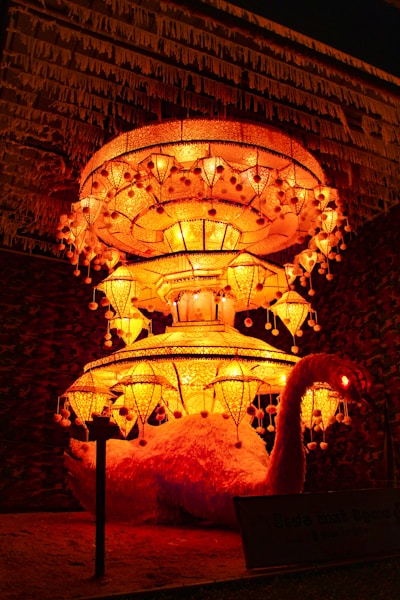 a lit display of lights in front of a building