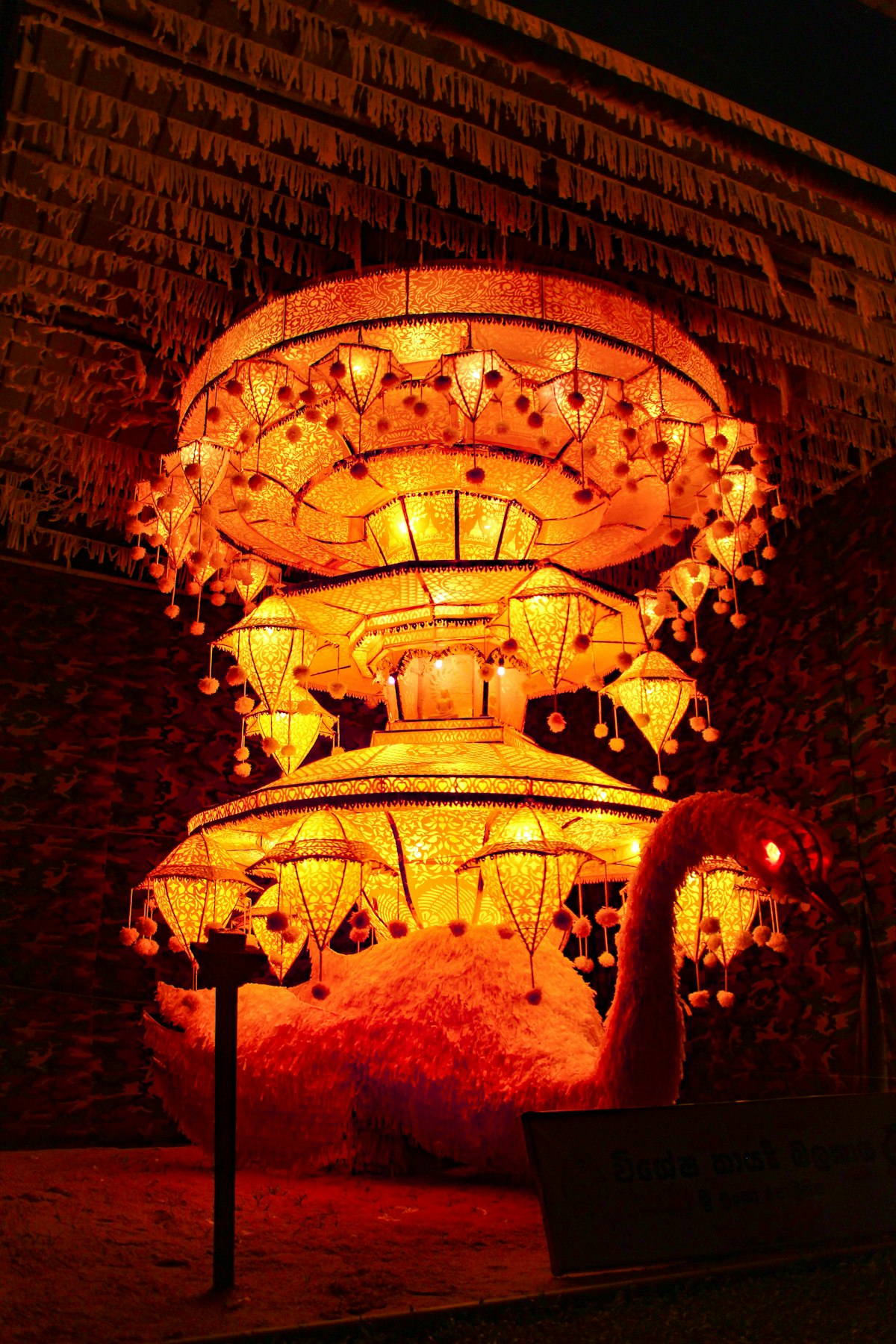 Sri Lanka May — elaborate Vesak lantern illuminated at night outside a temple in Colombo during the Buddhist full moon festival