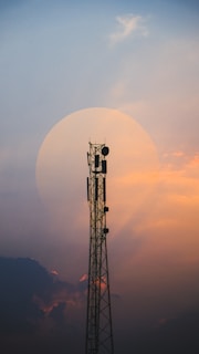 a tall tower with a cell phone on top of it