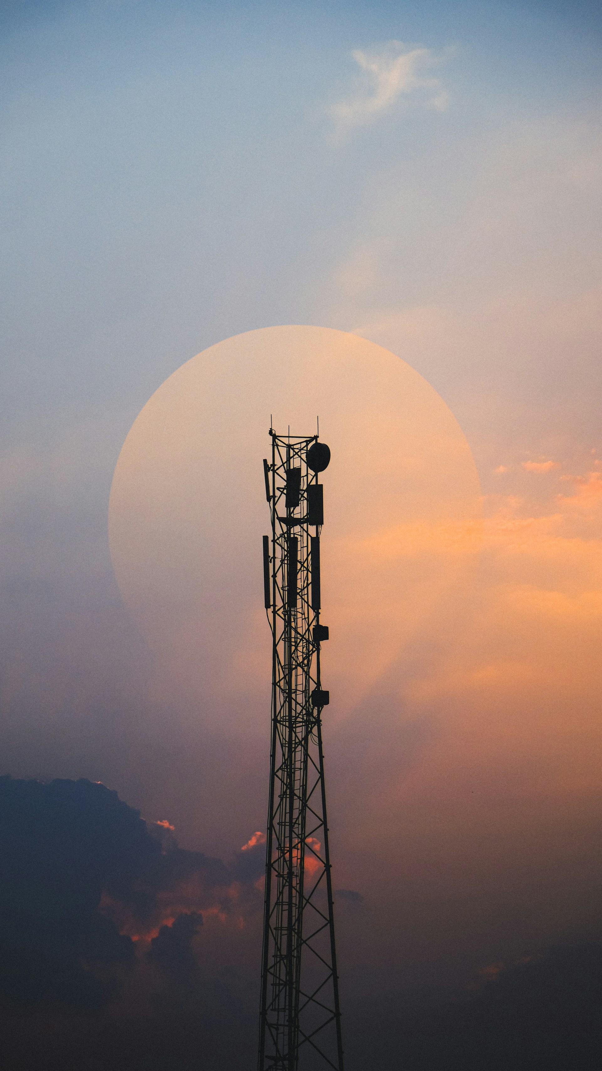 a tall tower with a cell phone on top of it