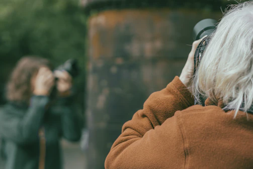 a woman taking a picture of another woman with a camera