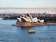 a boat is in the water near a large building
