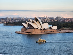 a boat is in the water near a large building