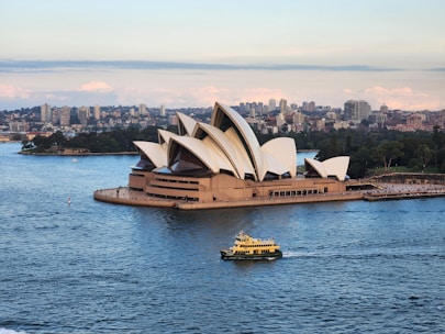 a boat is in the water near a large building