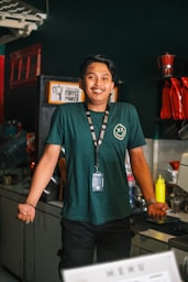 a man standing in a kitchen next to a washing machine