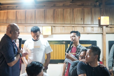 a group of people standing around each other