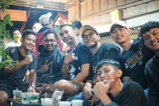 a group of young men sitting next to each other