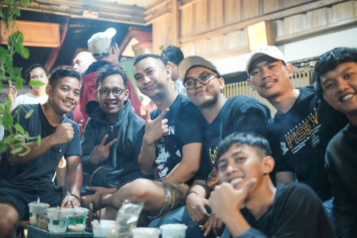 a group of young men sitting next to each other