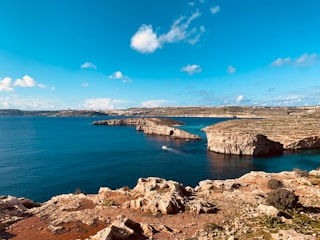 a body of water surrounded by rocky terrain