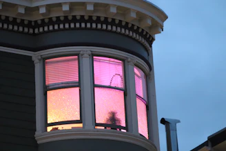 a house with a pink light in the window