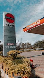 a gas station sign with a sky background