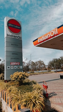 a gas station sign with a sky background